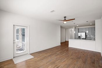 A room with wooden floors and a ceiling fan.